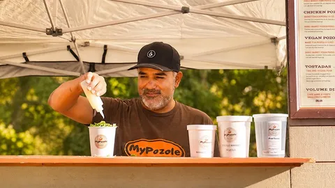Jorge, MyPozole's founder, topping a cup at the farmers market