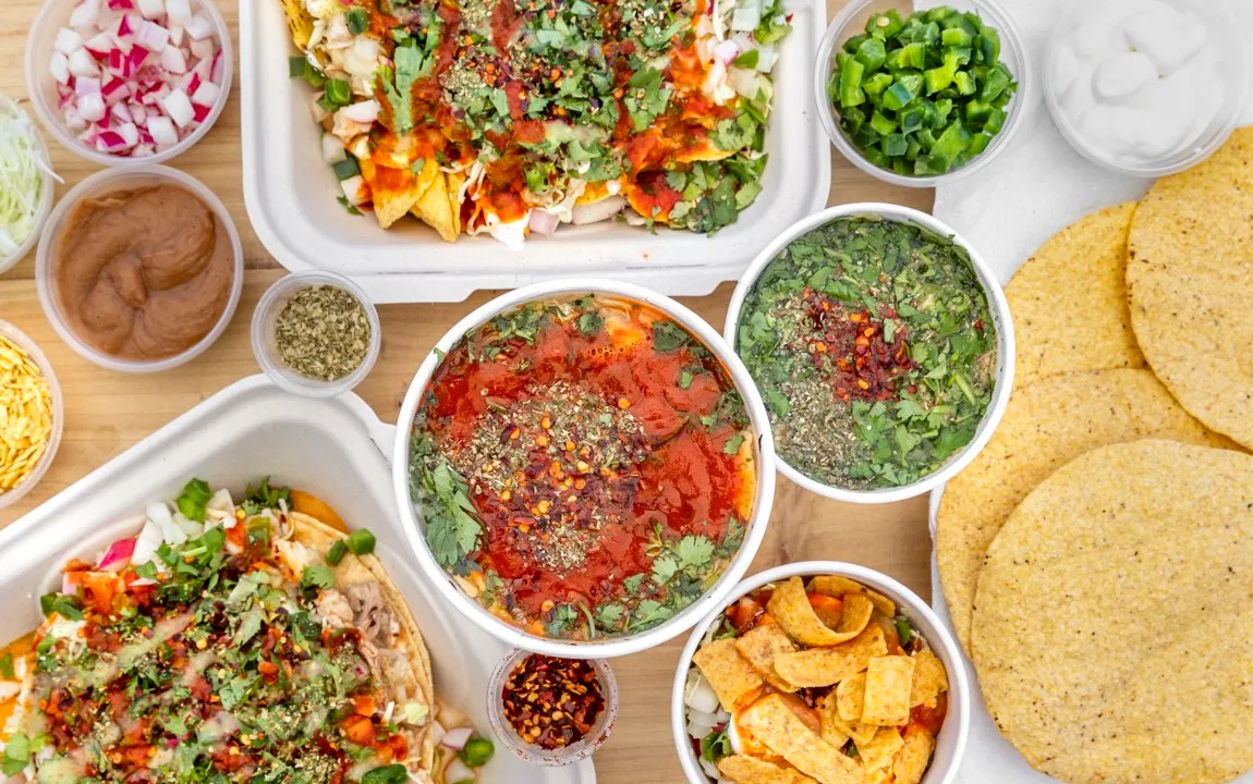 Overhead shot of a bowl of MyPozole, toppings laid out around it